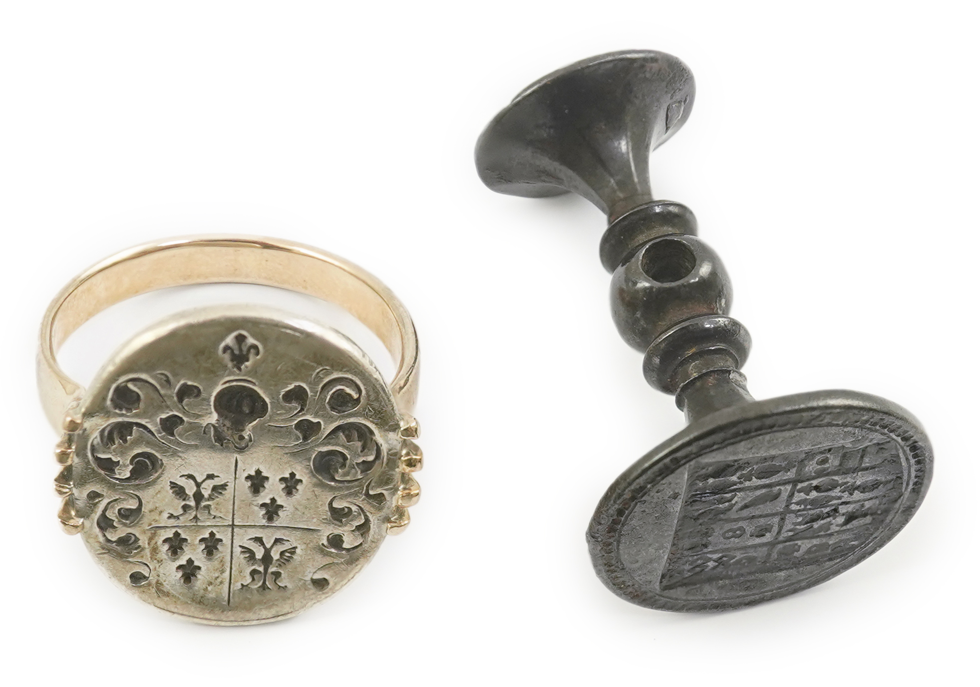 An early 18th century silver and gold signet ring, embossed with an armorial, size R, together with a steel double ended fob seal